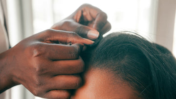 Hands caring for textured hair